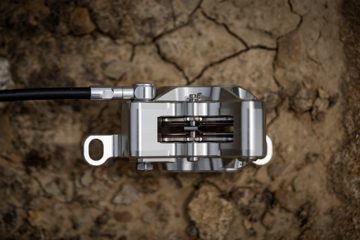 Top view of a silver Trickstuff C42 caliper showing the pad opening and retaining hardware.