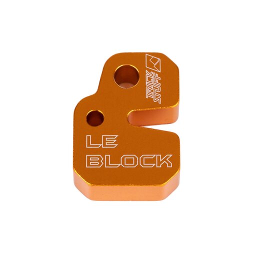 Orange Trickstuff Le Block bleed block with engraved lettering and mounting holes.