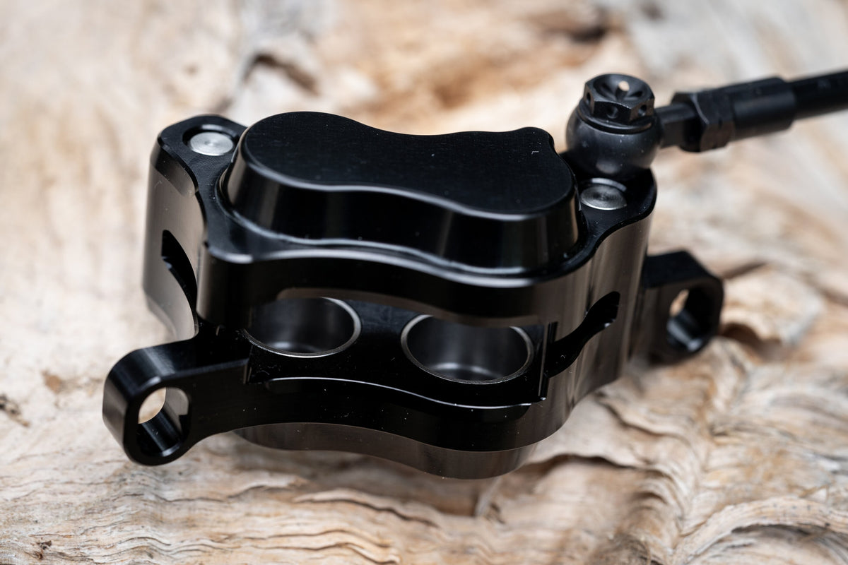 Black Trickstuff Maxima caliper with the hollow piston faces visible inside.