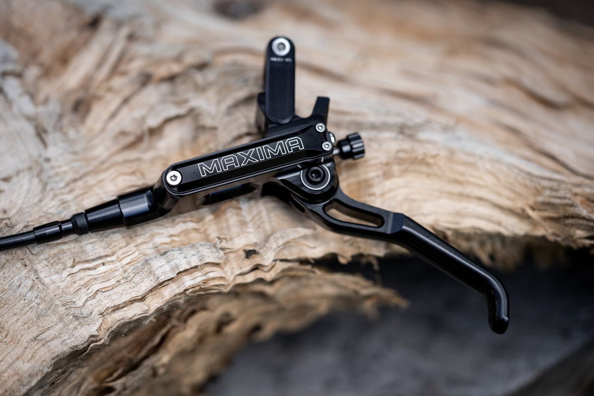 Black Trickstuff Maxima lever and pump body with the reservoir cap and adjustment dial visible.