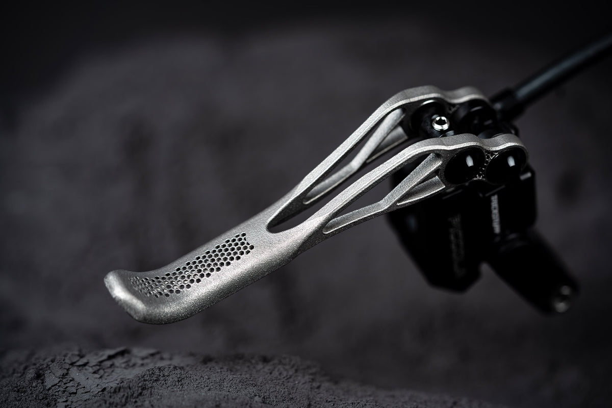 Trickstuff Piccola HD Titanium lever showing its textured honeycomb finger surface.