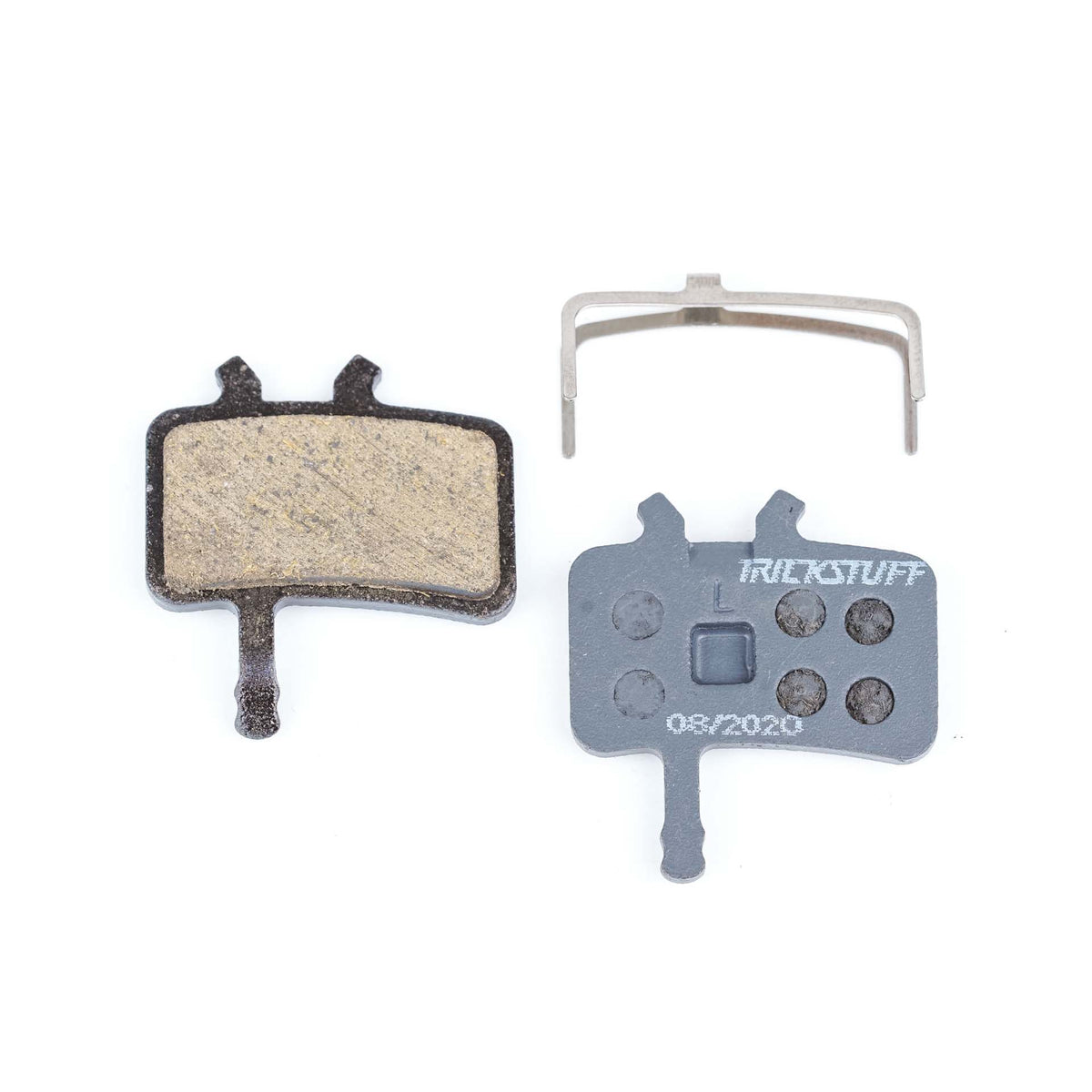 Trickstuff Standard 810 brake pads, showing friction and backing faces with a retaining spring.